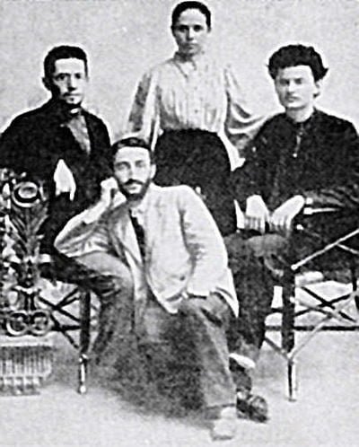 A primeira esposa de Trotsky, Aleksandra Sokolovskaya, com seu irmão (sentado à esquerda) e Trotsky (sentado à direita) em 1897.