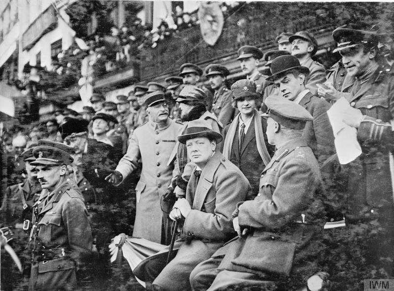 O Ministro das Munições, Winston Churchill, observando a marcha da 47ª (2ª Divisão de Londres) na Grande Place, Lille, França, outubro de 1918. À sua frente está o chefe do Estado-Maior da 47ª Divisão, Tenente Coronel Bernard Montgomery.